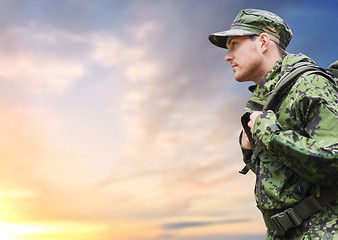 Image showing soldier in military uniform with backpack hiking