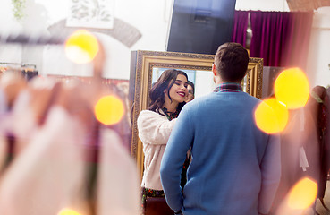 Image showing couple choosing clothes at vintage clothing store