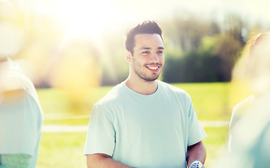 Image showing happy volunteer man in park