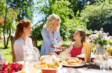 Image showing happy family having dinner at summer garden