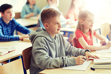 Image showing group of students with notebooks at school lesson