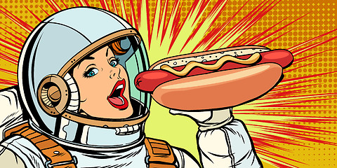 Image showing Hungry woman astronaut eating hot dog sausage