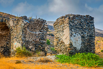 Image showing An ancient wall with an arch of stone built in the mountains.