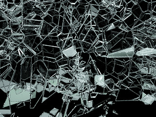 Image showing Pieces of splitted or cracked glass on black