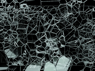 Image showing Pieces of shattered or cracked glass on black