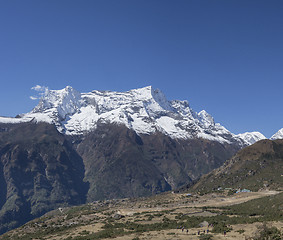 Image showing Group of trekkers on a hill and Himalaya summits near Namche Baz