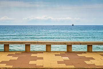 Image showing Container ship at anchor on the horizon