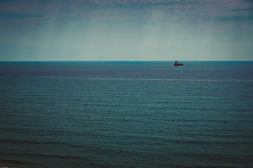 Image showing Container ship at anchor on the horizon