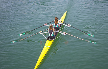 Image showing Two young women rowing race in lake