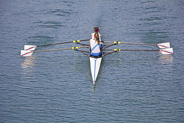 Image showing Two young women rowing race in lake