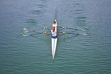 Image showing Two young women rowing race in lake