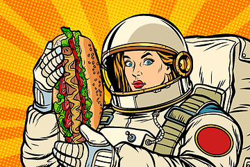 Image showing Hungry woman astronaut with hot dog