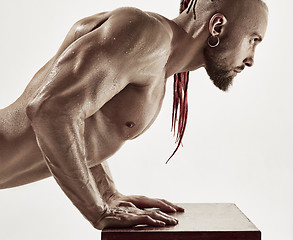 Image showing the handsome guy is wrung out on a table in the gym