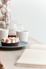 Image showing Cup of coffee, branch of tree, wooden windowsill