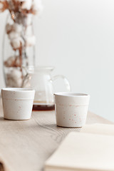 Image showing Cup of coffee, branch of tree, wooden windowsill