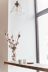 Image showing Cup of coffee, branch of tree, wooden windowsill