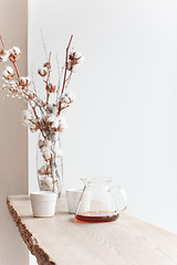 Image showing Cup of coffee, branch of tree, wooden windowsill