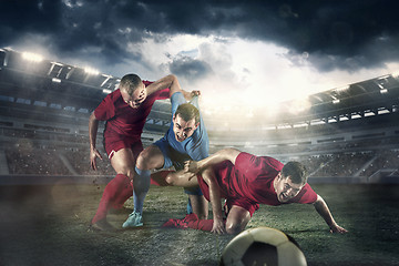 Image showing The football player in motion on the field of stadium