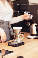 Image showing Hand drip coffee, Barista pouring water on coffee ground with filter