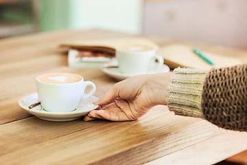 Image showing A table setting for coffee on the counter at a coffee house