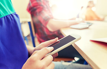 Image showing student girl with smartphone texting at school