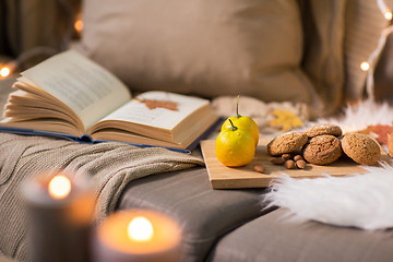 Image showing lemons, book, almond and oatmeal cookies on sofa