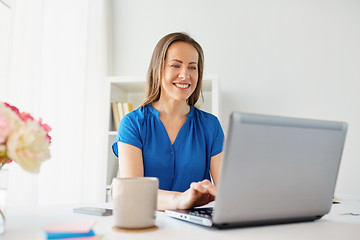 Image showing happy woman with laptop working at home or office
