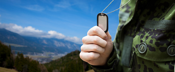 Image showing close up of young soldier with military badge