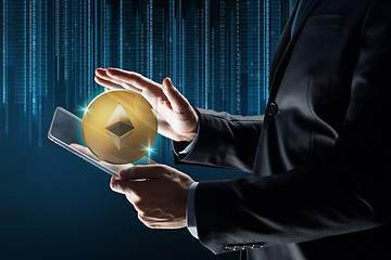 Image showing businessman with tablet pc and ethereum hologram