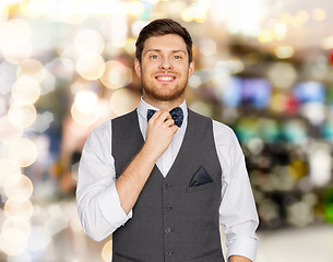 Image showing happy man in festive suit over lights