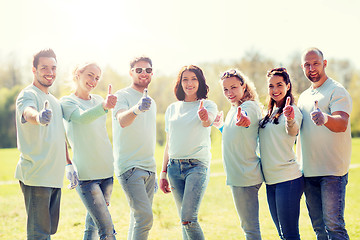 Image showing group of volunteers showing thumbs up in park