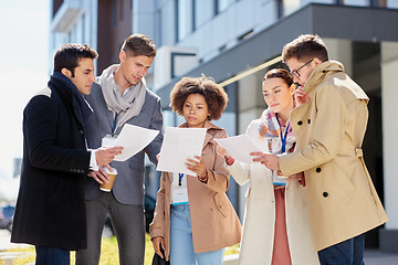 Image showing international business team with papers outdoors