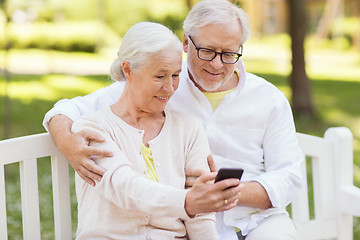 Image showing senior couple taking selfie by smartphone at park