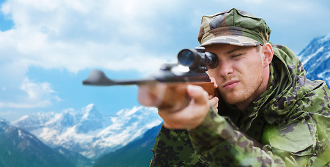 Image showing soldier or hunter with gun aiming or shooting