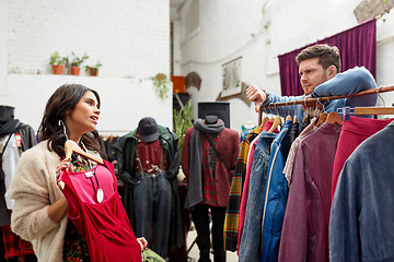 Image showing couple choosing clothes at vintage clothing store