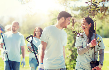 Image showing group of volunteers with trees and rake in park