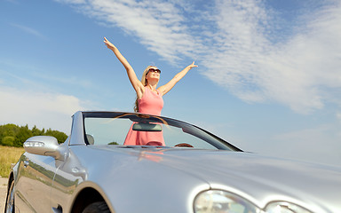 Image showing happy young woman in convertible car