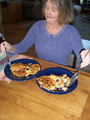 Image showing Female eating pancakes.