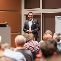 Image showing Business speaker giving a talk at conference meeting.