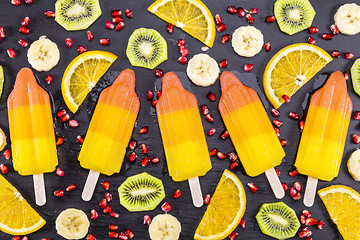 Image showing Fruit popsicles ice cream on black