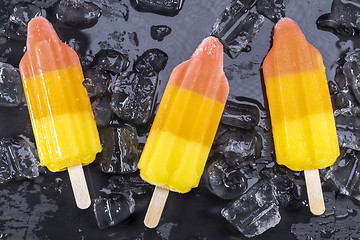 Image showing Fruit popsicles ice cream on black