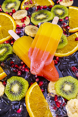 Image showing Fruit ice cream on stick with slices fruits  