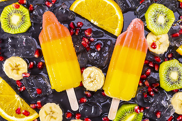 Image showing Fruit ice cream on stick with slices fruits 