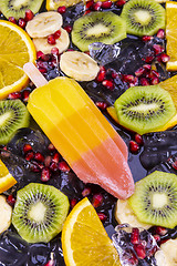 Image showing Fruit popsicles ice cream on black