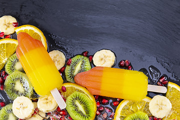 Image showing Fruit ice cream on stick with slices fruits 