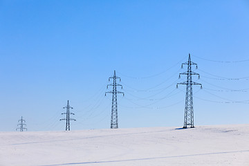 Image showing high voltage power lines against a blue sky