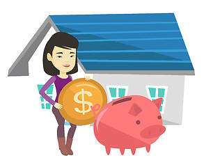 Image showing Woman puts money into piggy bank for buying house.