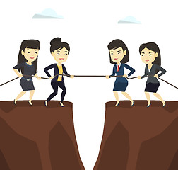 Image showing Two groups of business people pulling rope.