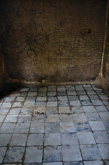 Image showing dirty tiled floor and brick wall empty room