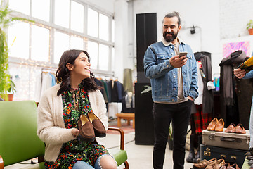 Image showing couple choosing footwear at vintage clothing store